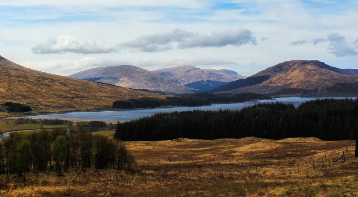 Sweeping Scottish Highland landscape with still loch waters